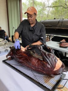 Chef Natalie Wright-Moore Clark cuts up a bar-b-qued pig.